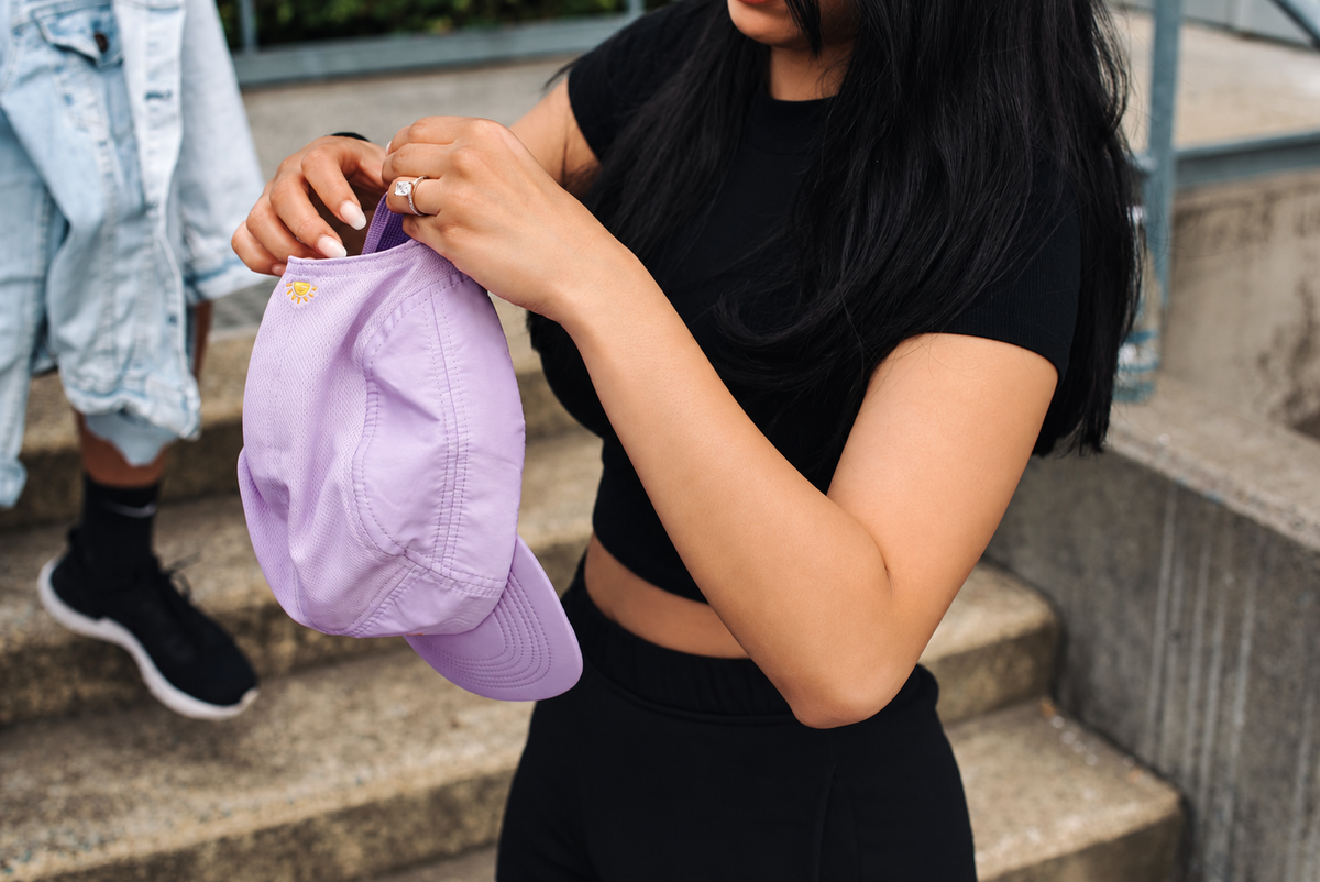 Lavender Helios cap held by its strap